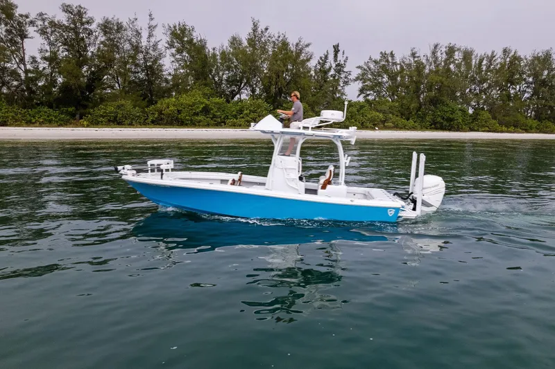 Slide: The Image of 2022 Barker Boatworks 26 Open on calm water near a forested shoreline. - 9