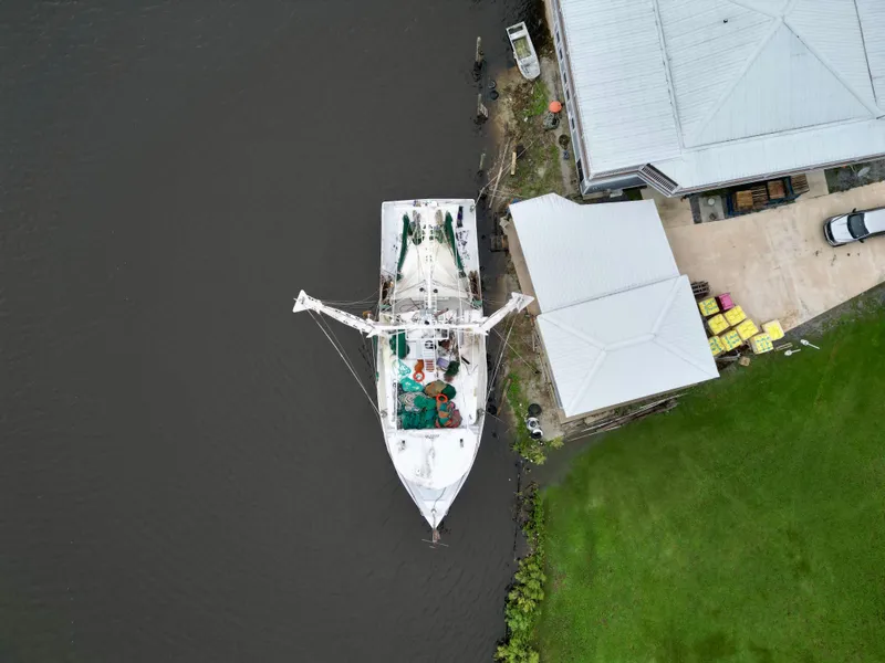 Slide: The Image of Aerial view of 2001 Blanchard 69 Shrimper/Freezer docked by a riverside building. - 13
