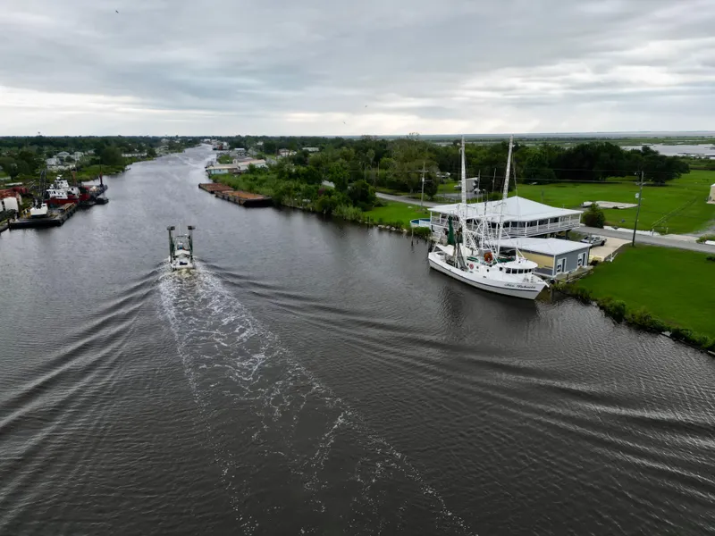 Slide: The Image of Aerial view of a 2001 Blanchard 69 Shrimper/Freezer boat on a river. - 14