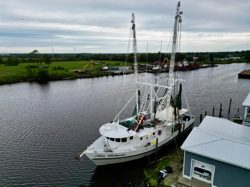 Slide: The Image of Aerial view of 2001 Blanchard 69 Shrimper/Freezer docked by a riverside. - 15