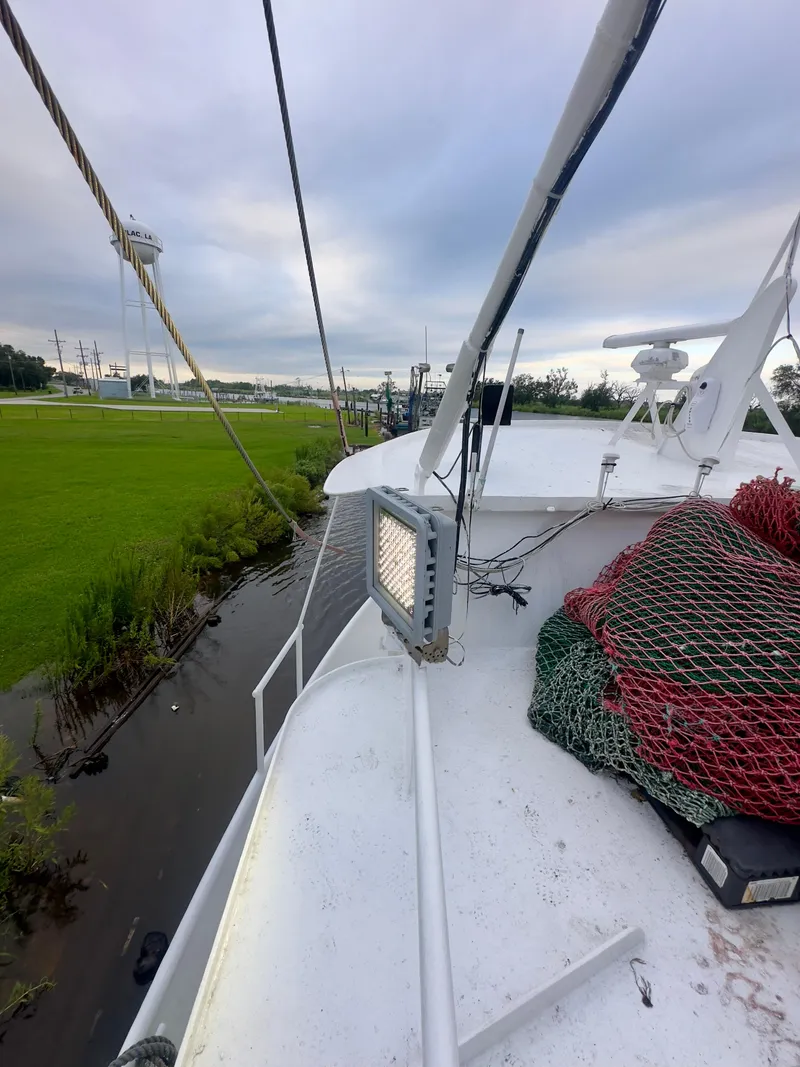 Slide: The Image of 2001 Blanchard 69 Shrimper/Freezer boat docked near grassy shoreline. - 18