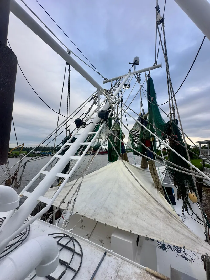 Slide: The Image of Blanchard 69 Shrimper/Freezer boat, 2001 model, docked with fishing nets and equipment. - 22