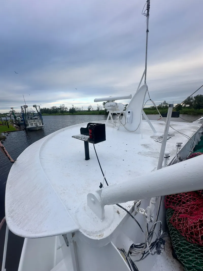 Slide: The Image of Blanchard 69 Shrimper/Freezer boat, 2001 model, docked with fishing equipment on deck. - 24