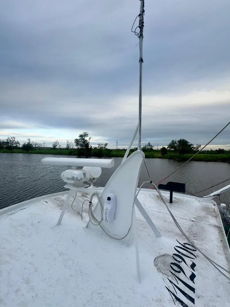 Slide: The Image of Blanchard 69 Shrimper/Freezer boat, 2001 model, on a calm river under cloudy skies. - 27