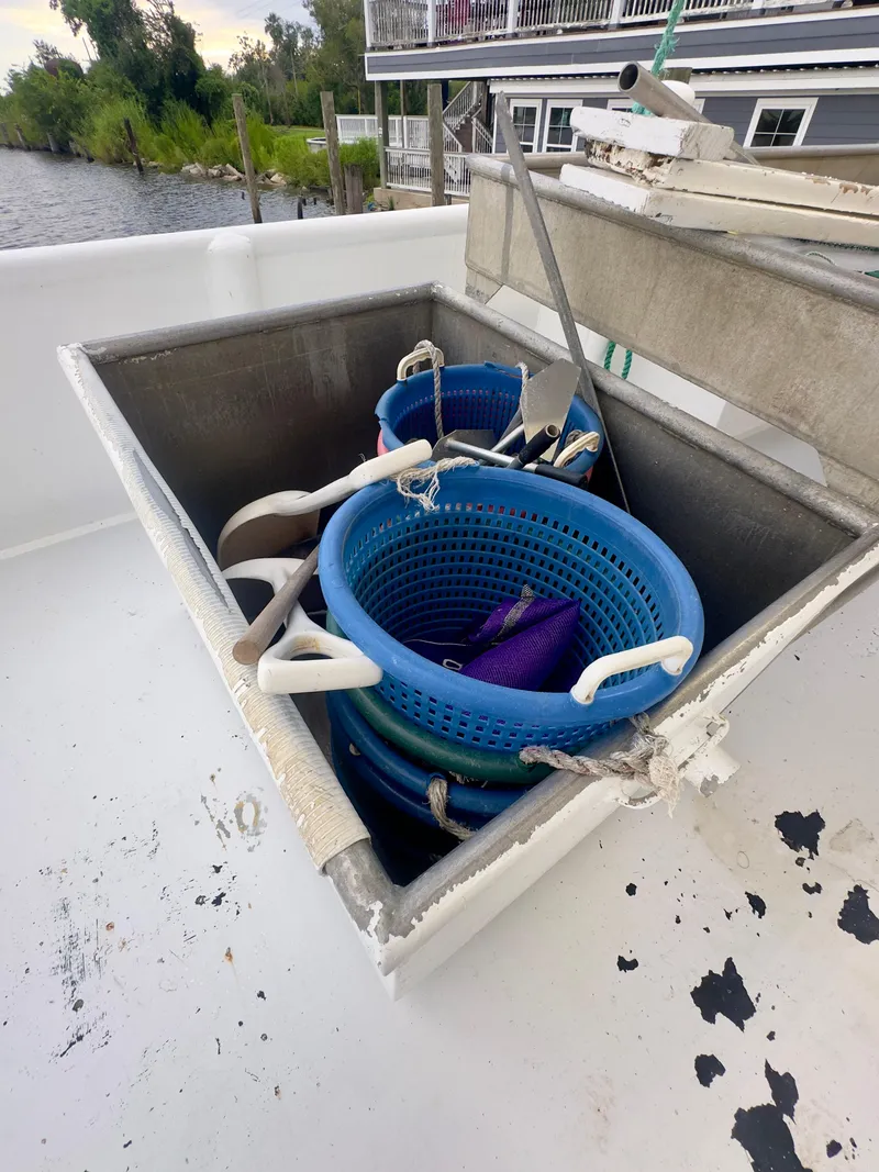 Slide: The Image of Blanchard 69 Shrimper/Freezer 2001 with blue baskets on deck, near water. - 28