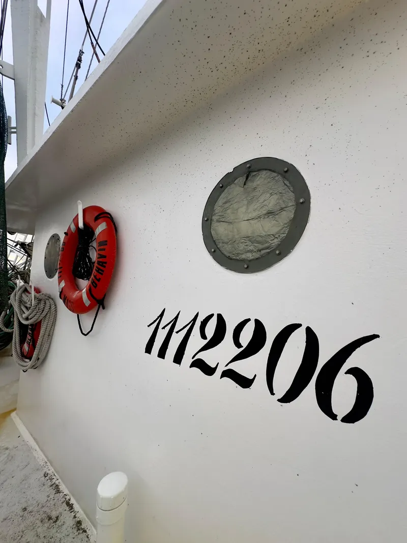 Slide: The Image of Fishing boat Blanchard 69 Shrimper/Freezer, 2001 model, with life preserver and number 1112206. - 33