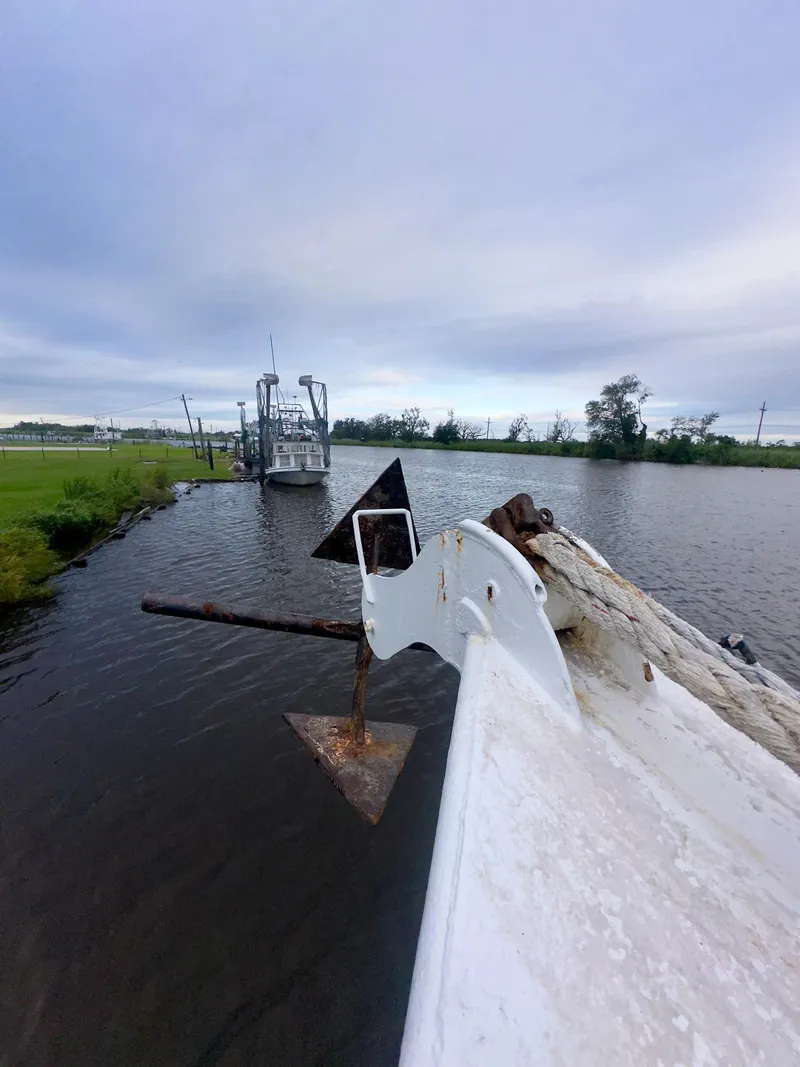 Slide: The Image of 2001 Blanchard 69 Shrimper/Freezer boat docked on a calm river under cloudy skies. - 35
