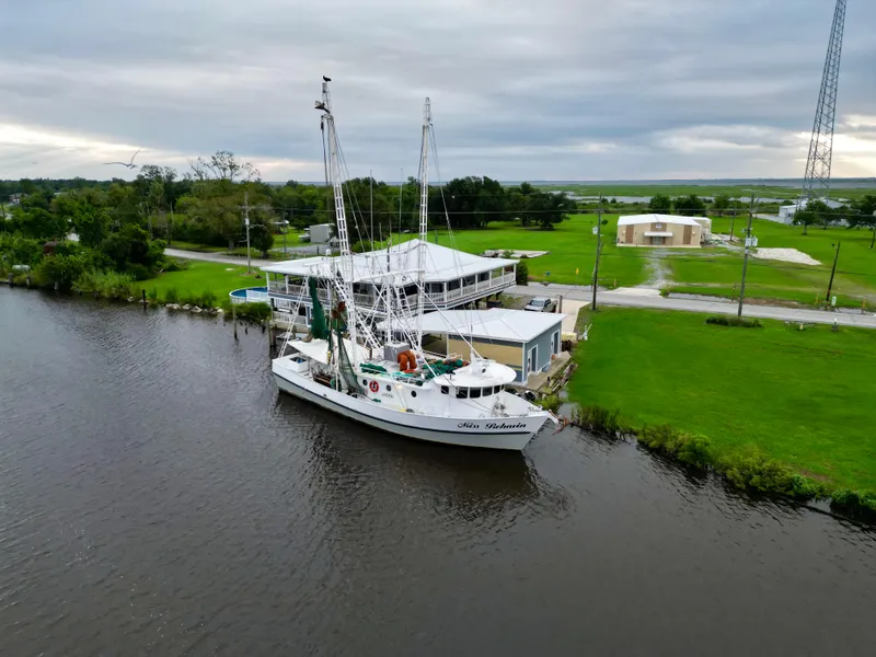 Slide: The Image of Aerial view of 2001 Blanchard 69 Shrimper/Freezer boat docked by a riverside building. - 4