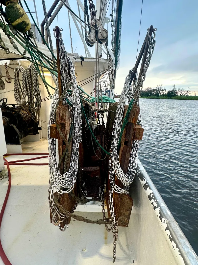 Slide: The Image of Blanchard 69 Shrimper/Freezer boat deck with chains, 2001 model, near water. - 46