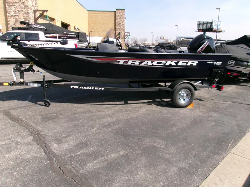 Slide: The Image of 2025 Tracker Pro Guide V-16 SC boat on trailer in parking lot. - 3