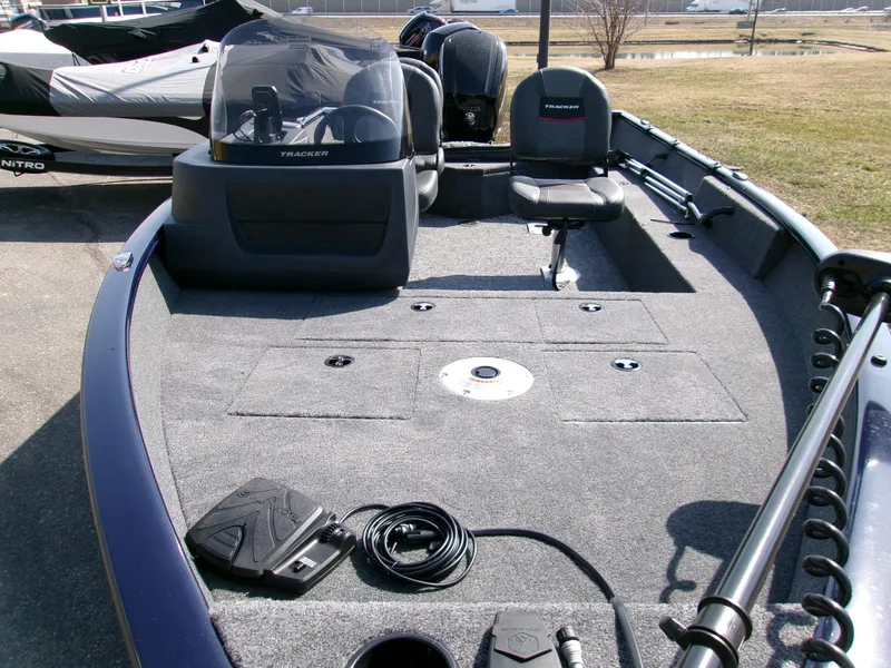 Slide: The Image of 2025 Tracker Pro Guide V-16 SC fishing boat interior with seating and control console. - 4