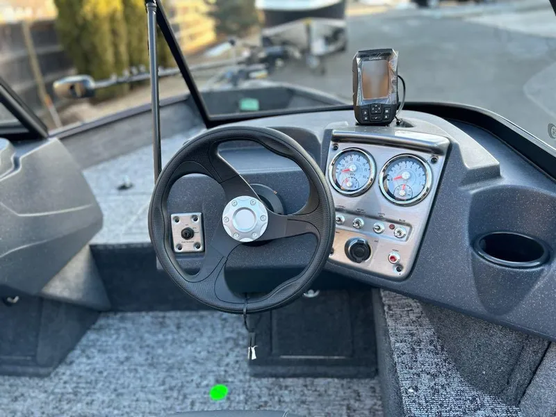 Slide: The Image of 2025 Tracker Pro Guide V-16 WT boat dashboard with steering wheel and gauges. - 3