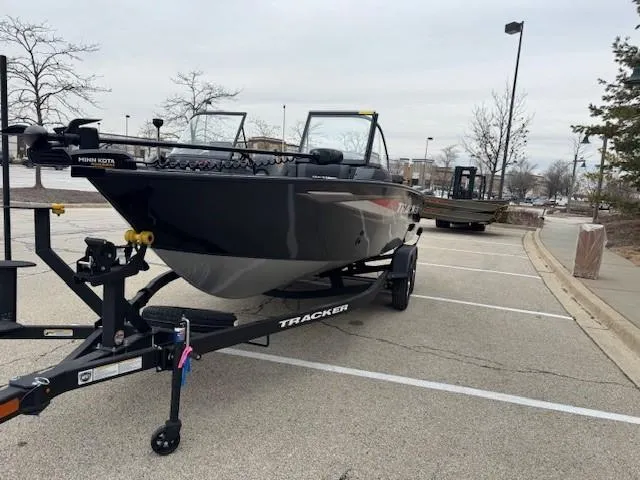 Slide: The Image of 2025 Tracker Targa V-18 WT boat on trailer in parking lot. - 2