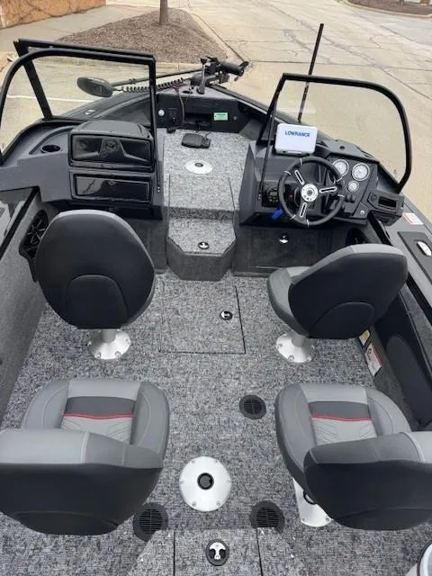 Slide: The Image of 2025 Tracker Targa V-18 WT boat interior with four seats and modern dashboard. - 3