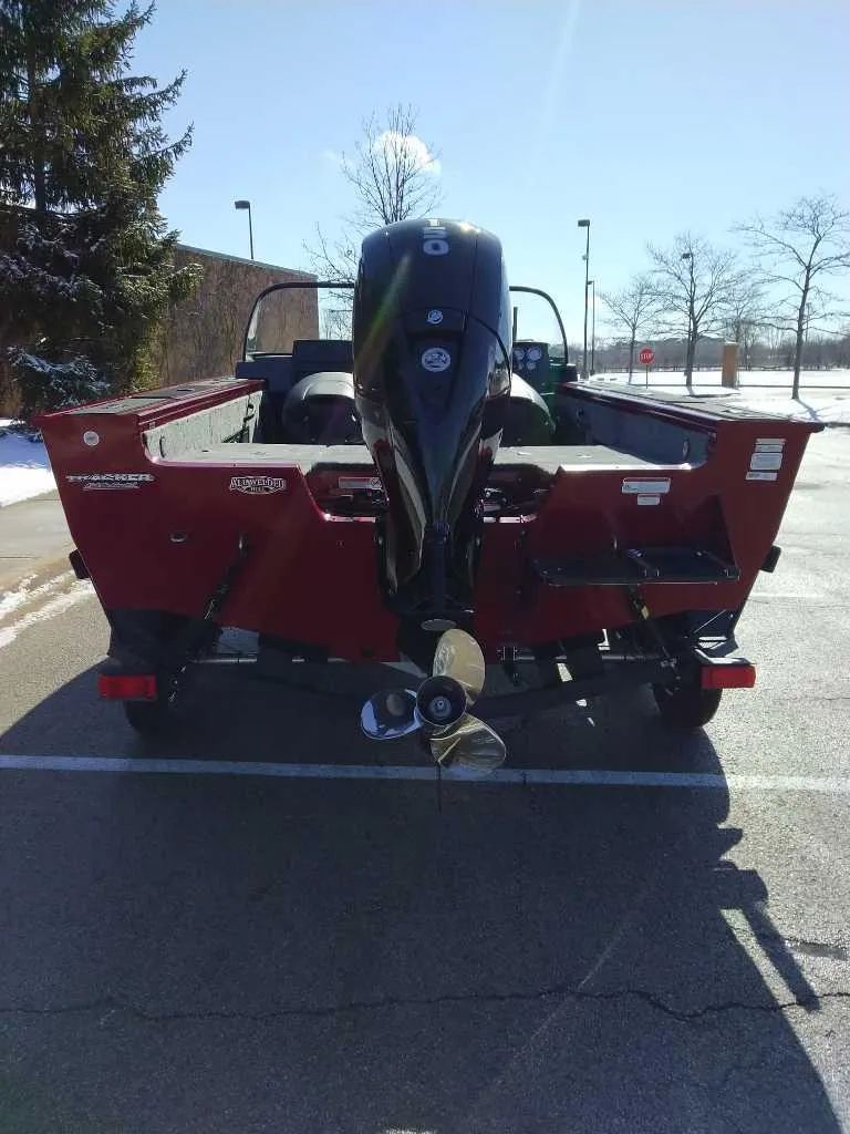 Slide: The Image of 2025 Tracker Targa V-18 Combo boat, rear view, parked outdoors on a sunny day. - 2
