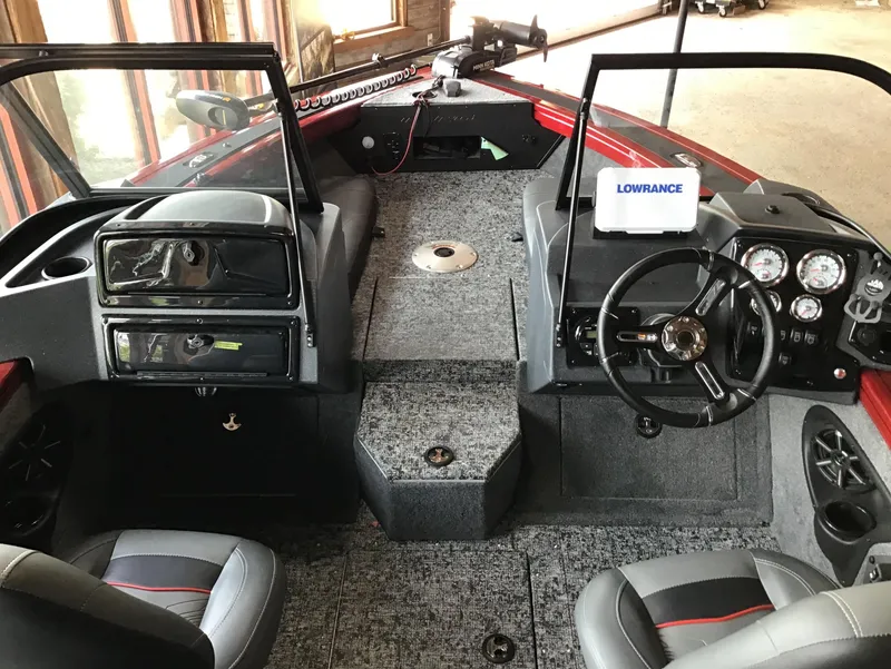Slide: The Image of 2025 Tracker Targa V-18 Combo boat interior with steering wheel and Lowrance electronics. - 2