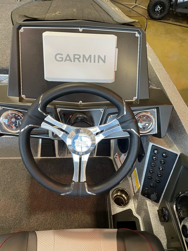 Slide: The Image of 2025 Ranger Z518 Cup-Equipped boat dashboard with Garmin navigation system and steering wheel. - 3