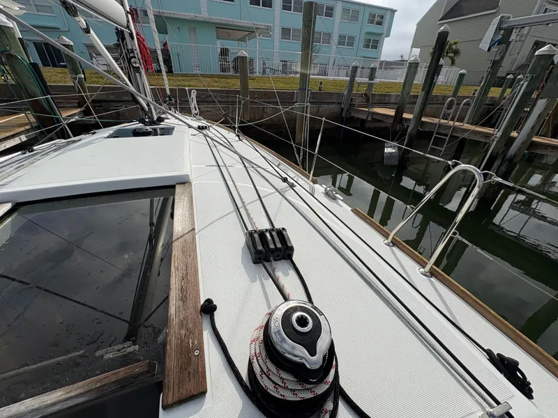 Slide: The Image of 2021 Jeanneau Sun Odyssey 349 sailboat docked, showcasing deck and rigging details. - 10