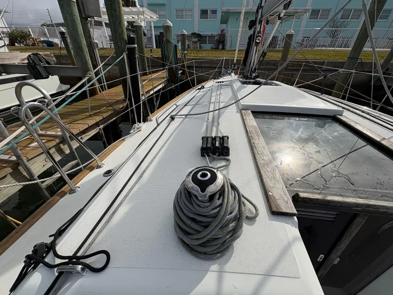 Slide: The Image of Deck view of 2021 Jeanneau Sun Odyssey 349 sailboat docked at marina. - 11