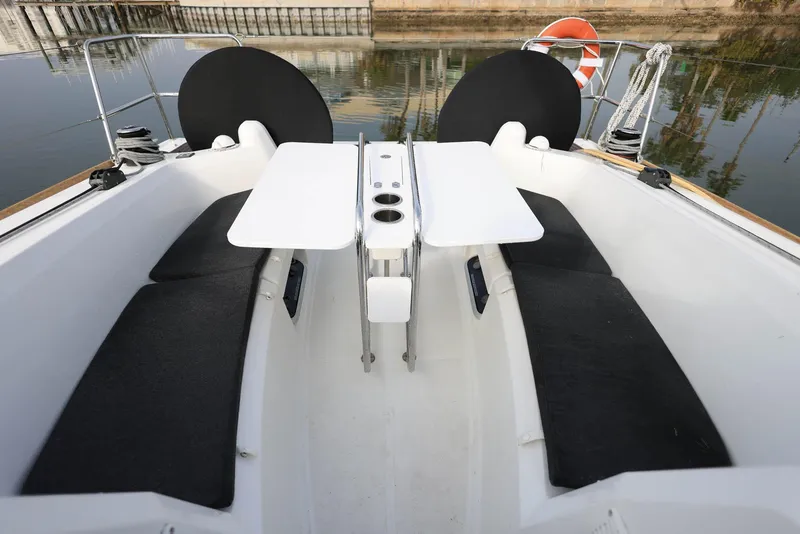 Slide: The Image of 2021 Jeanneau Sun Odyssey 349 cockpit with seating and dual tables. - 12