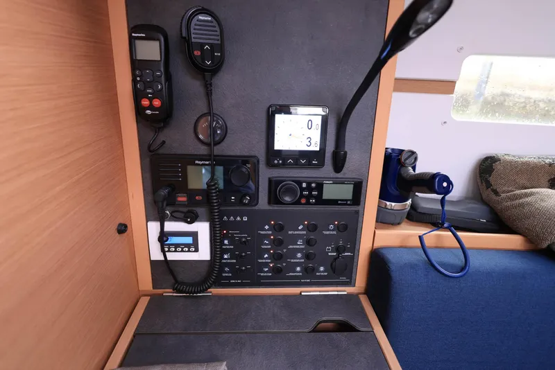 Slide: The Image of Control panel of 2021 Jeanneau Sun Odyssey 349 sailboat, featuring navigation and communication equipment. - 17