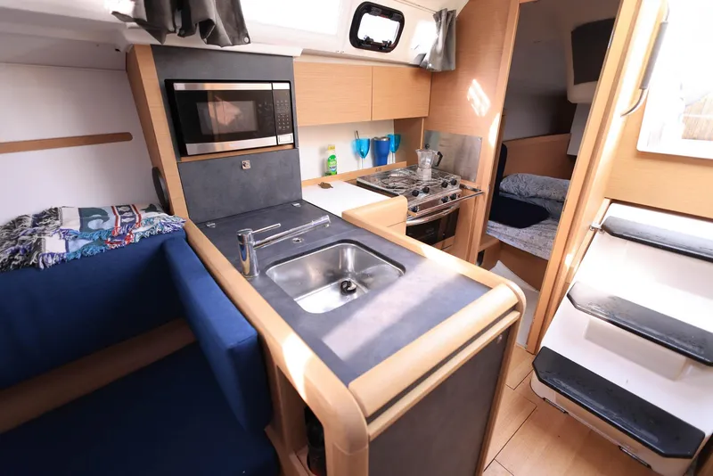Slide: The Image of Interior of 2021 Jeanneau Sun Odyssey 349 sailboat with modern kitchen and cozy seating. - 19