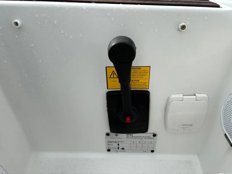 Slide: The Image of Control lever on a 2021 Jeanneau Sun Odyssey 349 sailboat cockpit panel. - 28