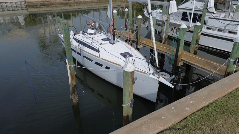 Slide: The Image of 2021 Jeanneau Sun Odyssey 349 sailboat docked in a marina. - 5