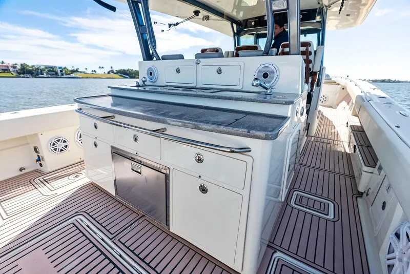 Slide: The Image of Luxury deck of 2018 HCB 53 Sueños boat with sleek cabinetry and seating. - 16