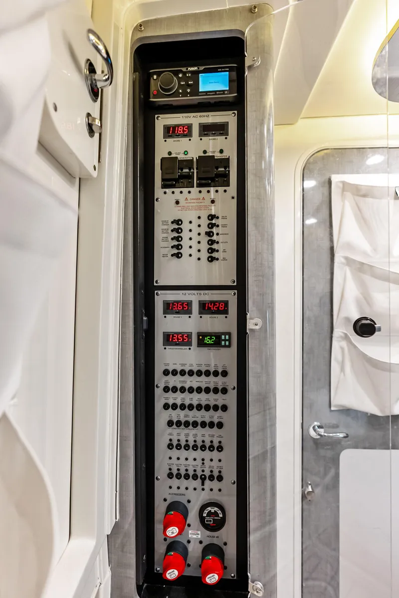 Slide: The Image of Control panel inside 2018 HCB 53 Sueños boat, featuring various switches and digital displays. - 30