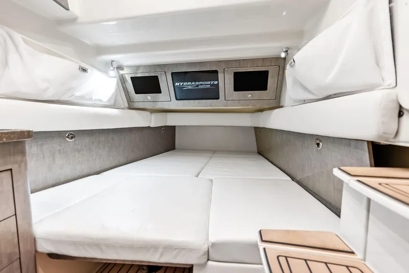 Slide: The Image of Interior cabin of 2018 HCB 53 Sueños boat with white cushioned seating. - 31