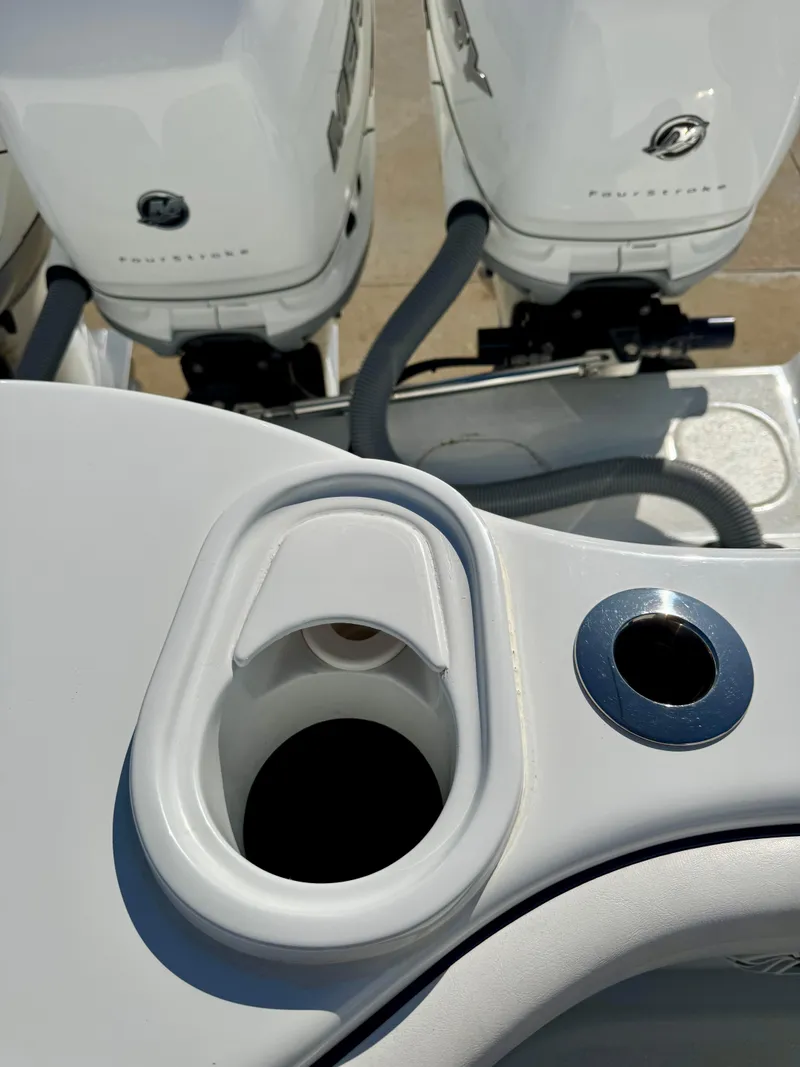 Slide: The Image of 2020 Yellowfin 42 Offshore boat with dual outboard engines and cup holder detail. - 12