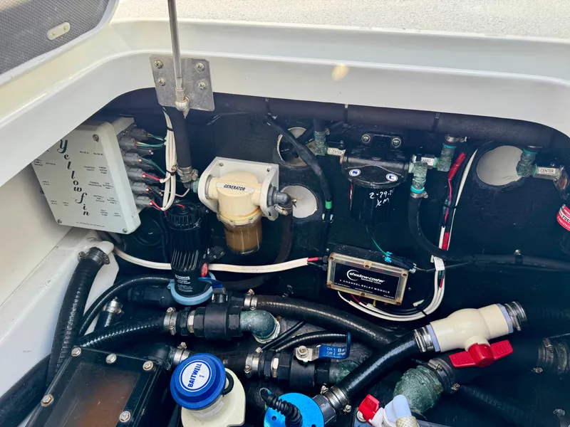 Slide: The Image of Engine compartment of a 2020 Yellowfin 42 Offshore boat, showcasing various mechanical components. - 14