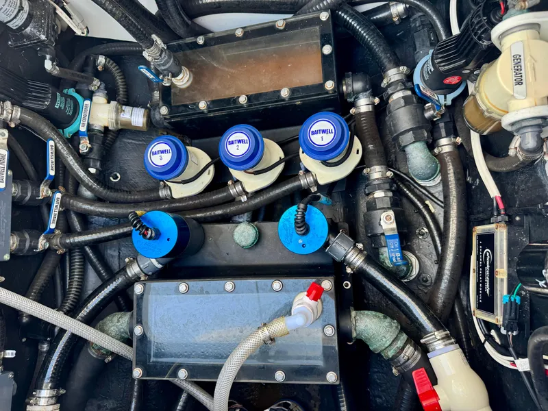 Slide: The Image of Engine compartment of a 2020 Yellowfin 42 Offshore boat with various hoses and components. - 16