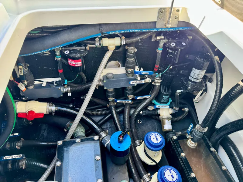 Slide: The Image of Engine compartment of a 2020 Yellowfin 42 Offshore boat with visible hoses and components. - 17