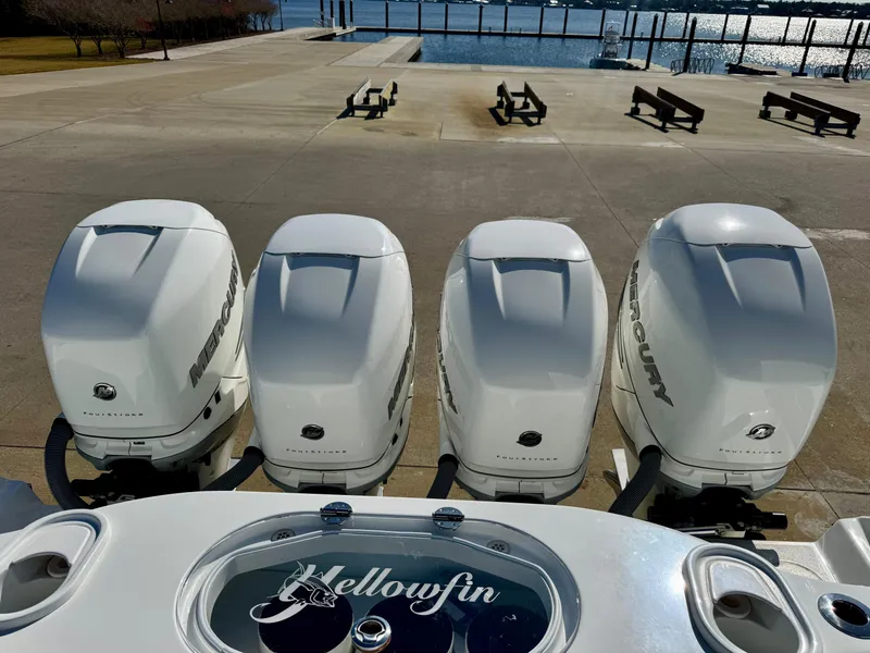 Slide: The Image of Four Mercury outboard engines on a 2020 Yellowfin 42 Offshore boat by the water. - 19