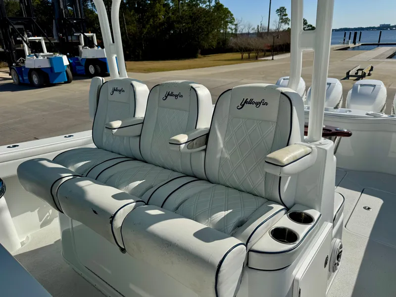 Slide: The Image of 2020 Yellowfin 42 Offshore boat seating with embroidered logos, dockside view. - 34