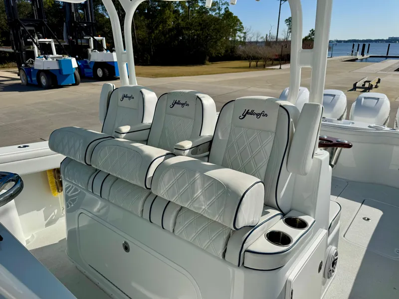 Slide: The Image of 2020 Yellowfin 42 Offshore boat seating with cup holders, docked near water. - 36