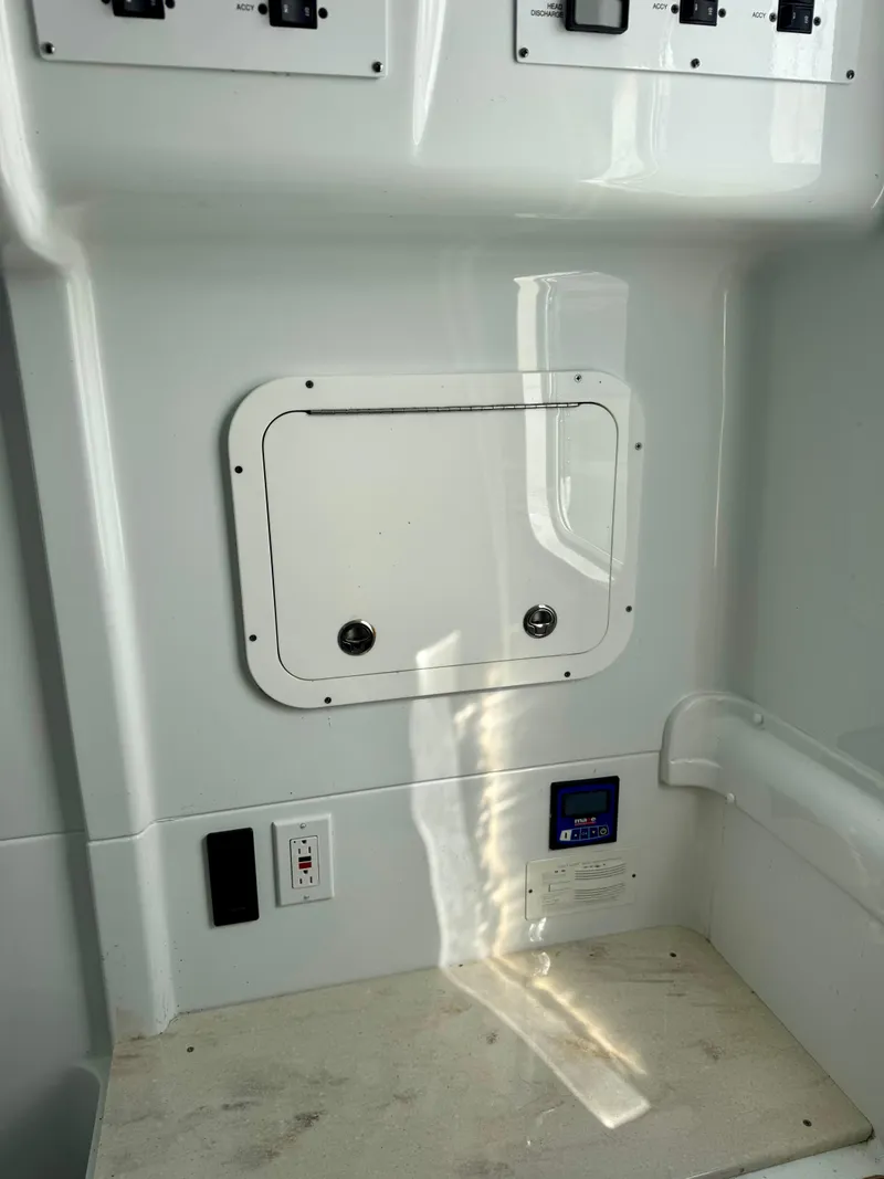 Slide: The Image of 2020 Yellowfin 42 Offshore boat interior with control panel and storage compartment. - 37