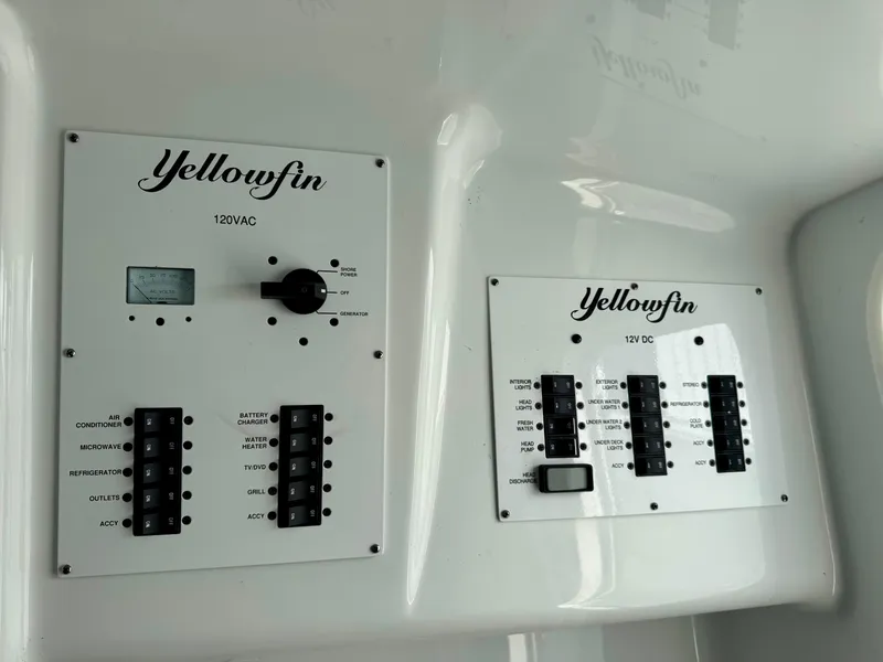 Slide: The Image of Control panels on a 2020 Yellowfin 42 Offshore boat, featuring 120VAC and 12VDC systems. - 38