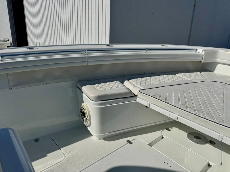 Slide: The Image of 2020 Yellowfin 42 Offshore boat interior with cushioned seating and table. - 43