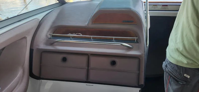 Slide: The Image of Interior of a 2010 Cobalt 323 boat, featuring dashboard and storage compartments. - 12