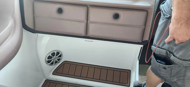 Slide: The Image of 2010 Cobalt 323 boat interior with storage compartments and speaker. - 13