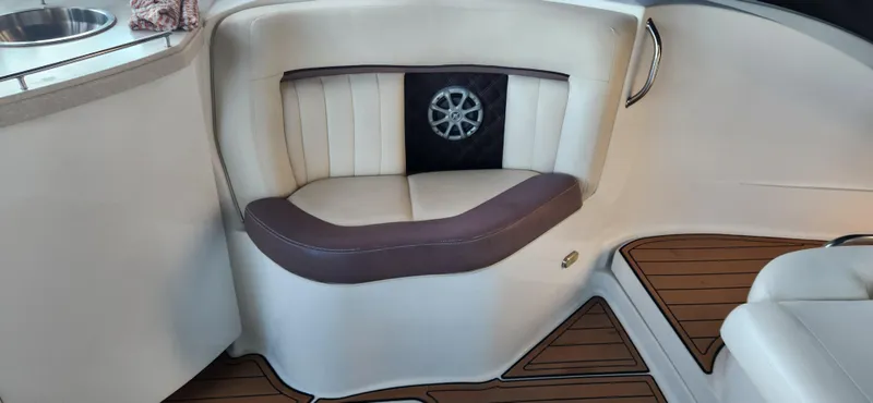 Slide: The Image of 2010 Cobalt 323 boat interior with cushioned seating and wood-style flooring. - 14