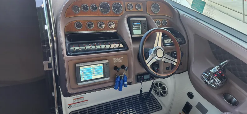 Slide: The Image of 2010 Cobalt 323 boat dashboard with wood accents and modern controls. - 19