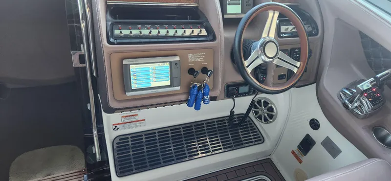 Slide: The Image of Interior dashboard of a 2010 Cobalt 323 boat with steering wheel and control panel. - 20