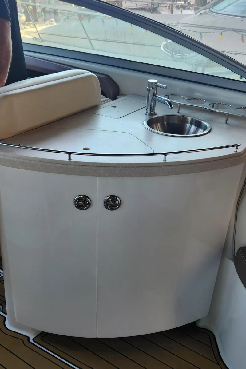 Slide: The Image of 2010 Cobalt 323 yacht interior with sink and storage cabinet. - 24