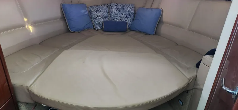 Slide: The Image of 2010 Cobalt 323 cabin interior with beige seating and blue cushions. - 27