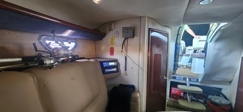 Slide: The Image of Interior of a 2010 Cobalt 323 boat, featuring seating and fishing equipment. - 35