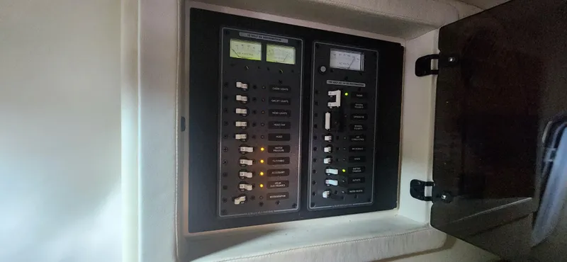 Slide: The Image of Electrical panel inside a 2010 Cobalt 323 boat, featuring switches and indicators. - 36